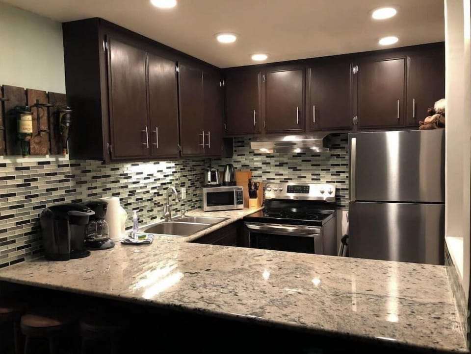 Open spaced kitchen with granite countertop, and cooking amenities. 
