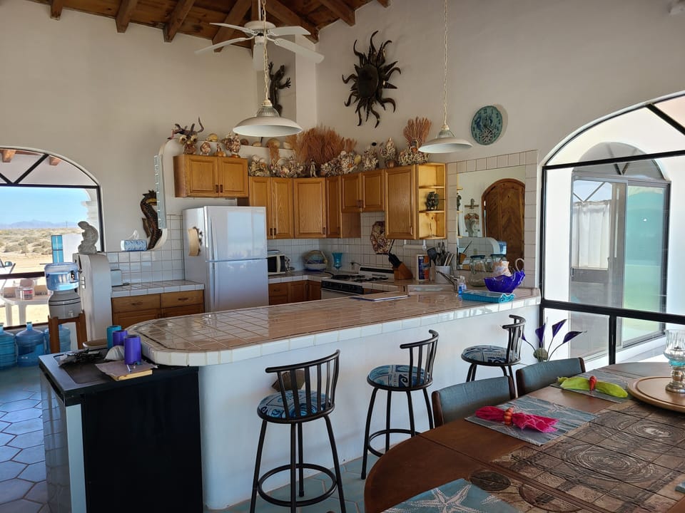 Kitchen faces gated entry courtyard and beach patios. Eat In Bar