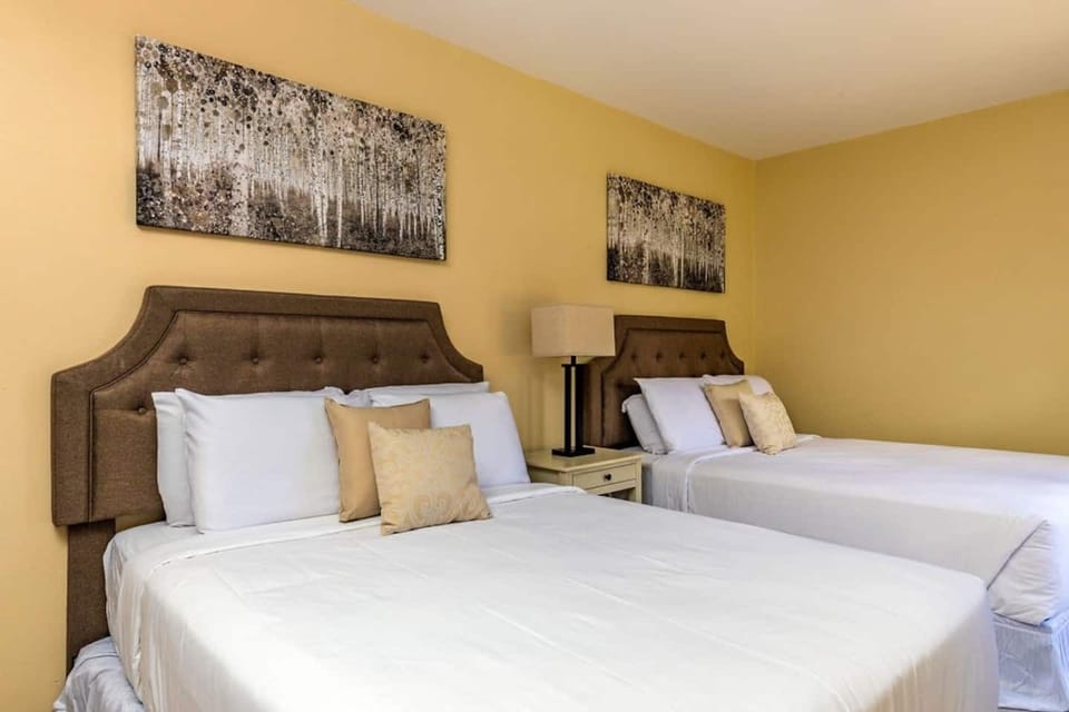 This bedroom features 2 queen size beds, a bright interior, an elegant headboard, and a comfortable mattress than can sleeps 4 guest