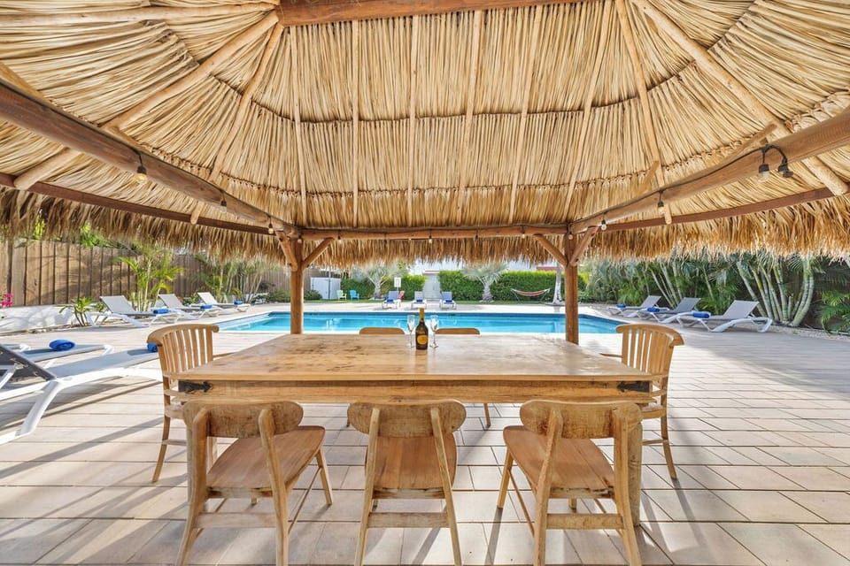 Enjoy the fresh air and sunshine while dining al fresco at this outdoor seating area featuring a BBQ grill
