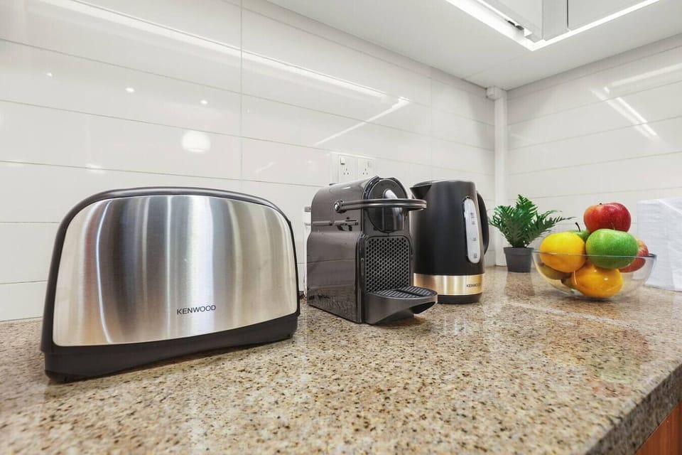 Kitchen: Modern appliances and fresh fruits await your culinary adventures!