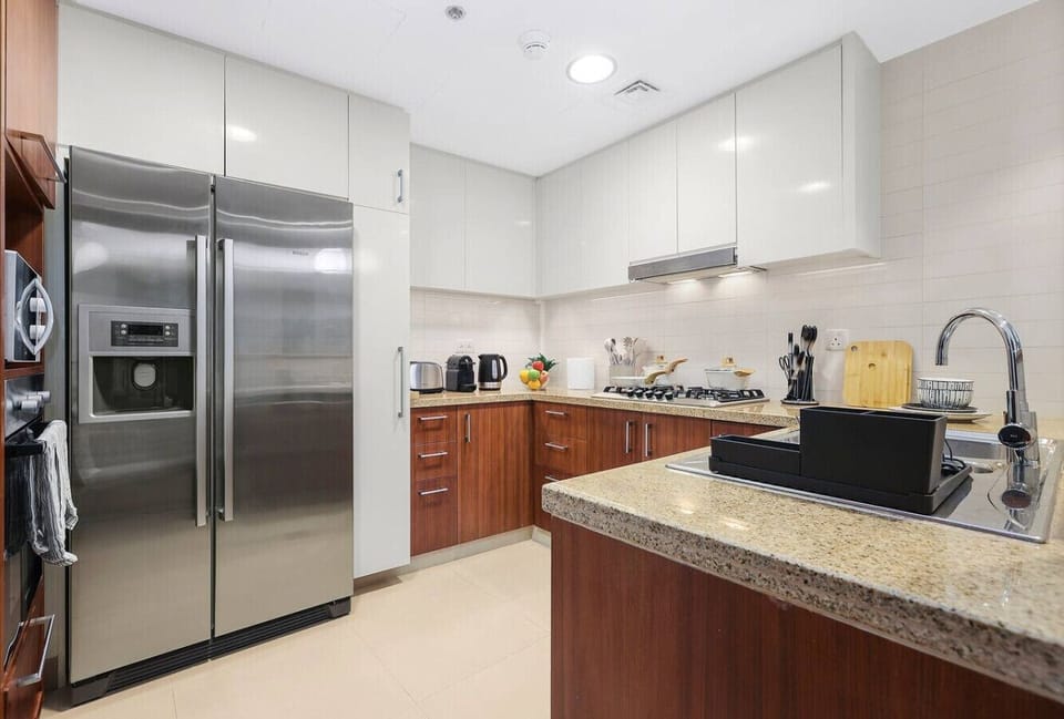 Kitchen: Sleek appliances and ample counter space create a culinary haven for your Dubai adventure!