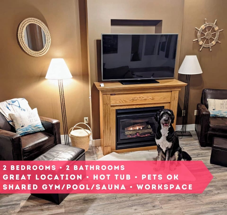 Snuggle up by the glowing fireplace in this inviting living space.