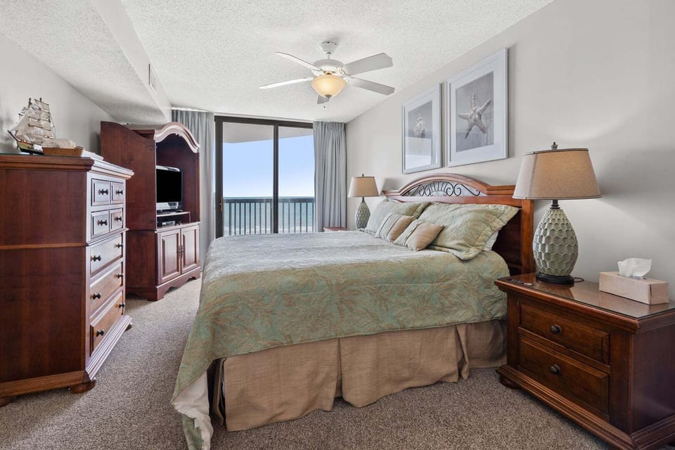 Bedroom opening to the balcony with an ocean view at Ocean Bay Club 604, a 4-bedroom Ocean Drive rental