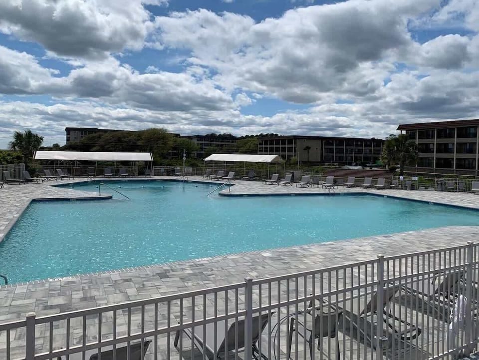 Relax by the massive resort-style swimming pool, featuring plenty of lounge seating.

Stay active during your stay in the fully equipped fitness room, featuring treadmills.