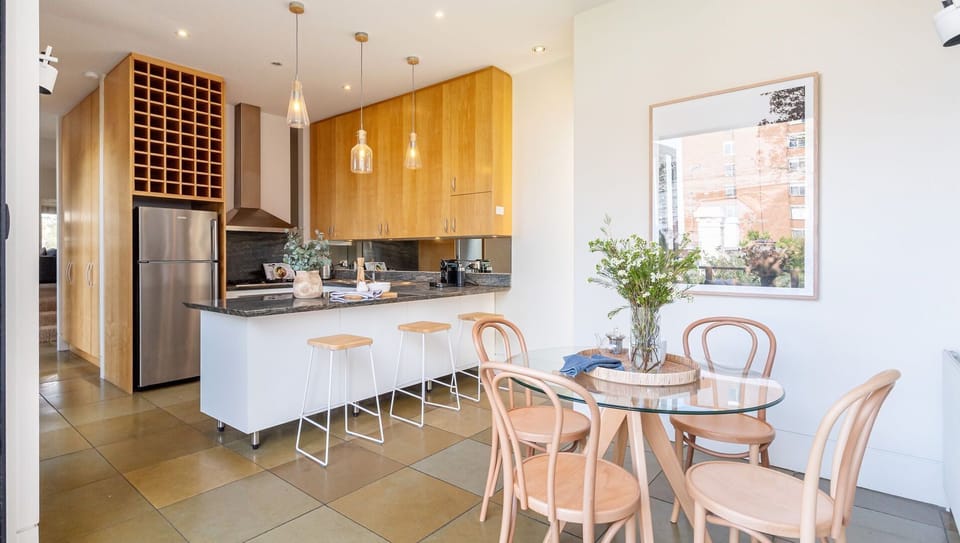 Kitchen with breakfast bar seating and meals area
