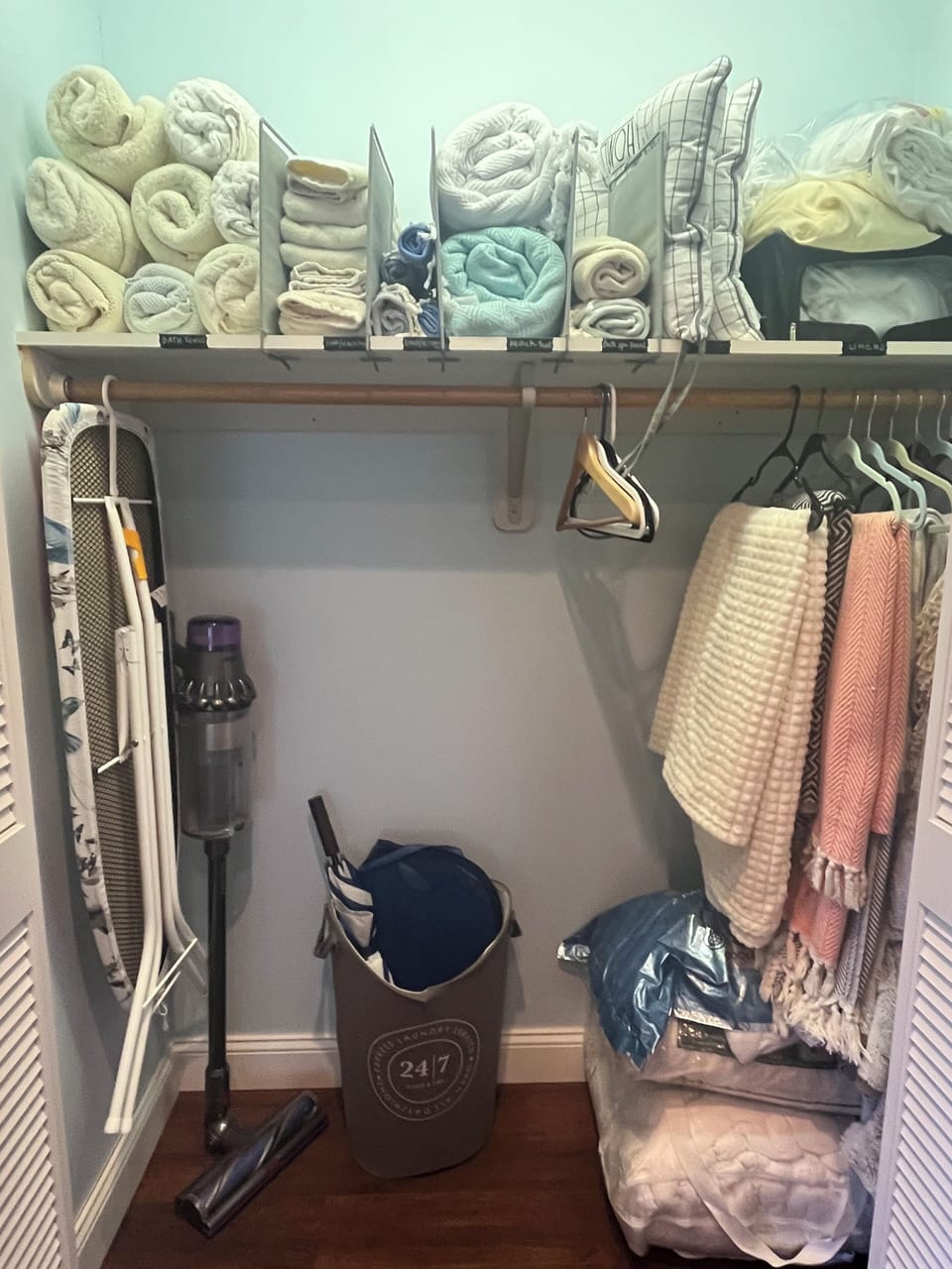 Closet with towels, ironboard, throws and extra set of pillows for guests to use