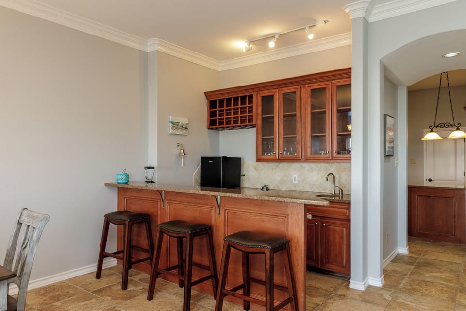 Your elegant kitchen awaits with rich cherry cabinets, granite counters, and a convenient breakfast bar perfect for morning coffee or evening wine.