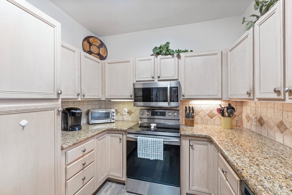 Your fully equipped kitchen awaits with granite counters, stainless appliances, and all the comforts of home for memorable meals.