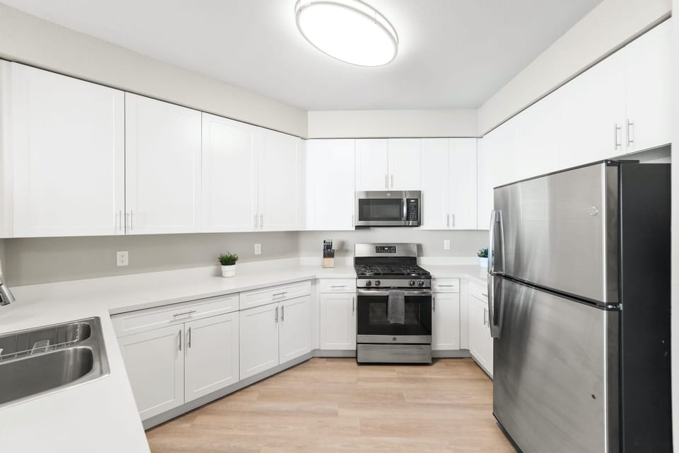 Full kitchen with stainless steel appliances.