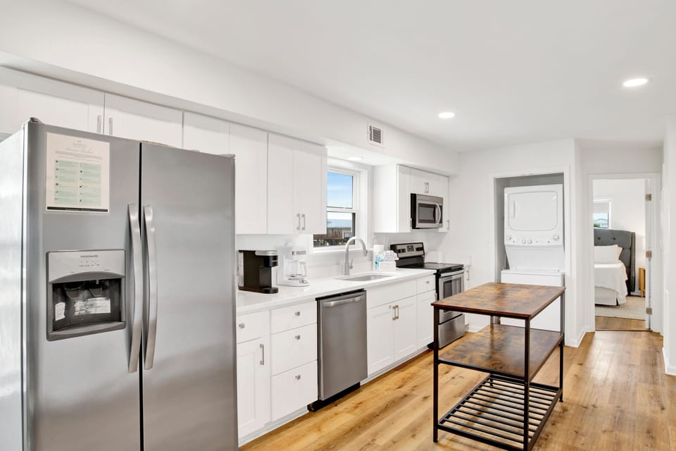 The kitchen is fully equipped and has stainless appliances
