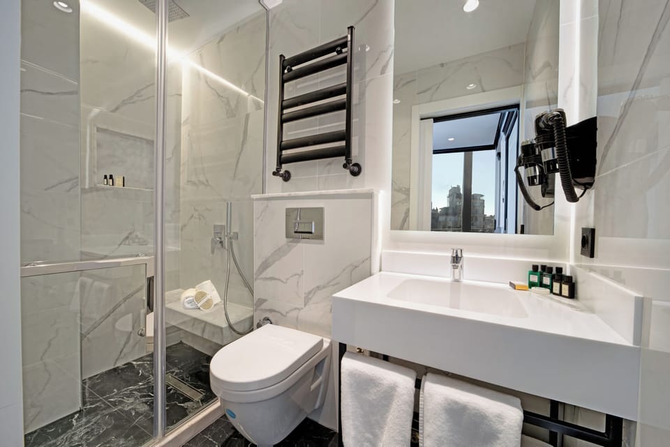Shower, rainfall showerhead, designer toiletries, hair dryer