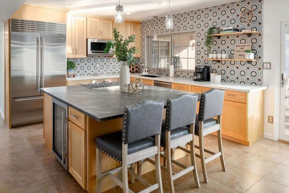 Indoor chef's kitchen fully remodeled with amazing tile design and a sit up island.