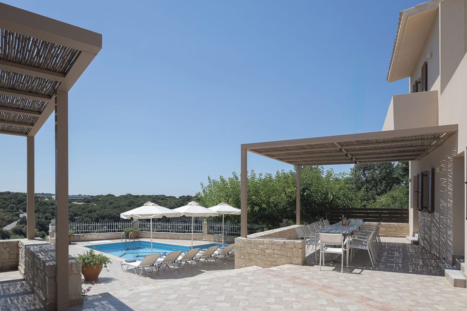 Swim surrounded by countryside calm in Antigoni Villa’s private outdoor setting.