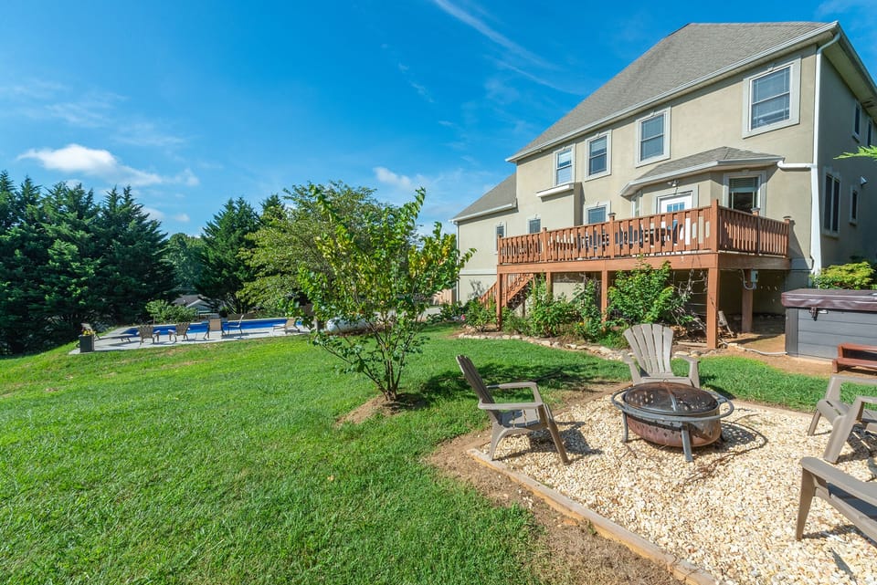 Expansive Backyard Featuring a Fenced Pool and Private Fire Pit.
