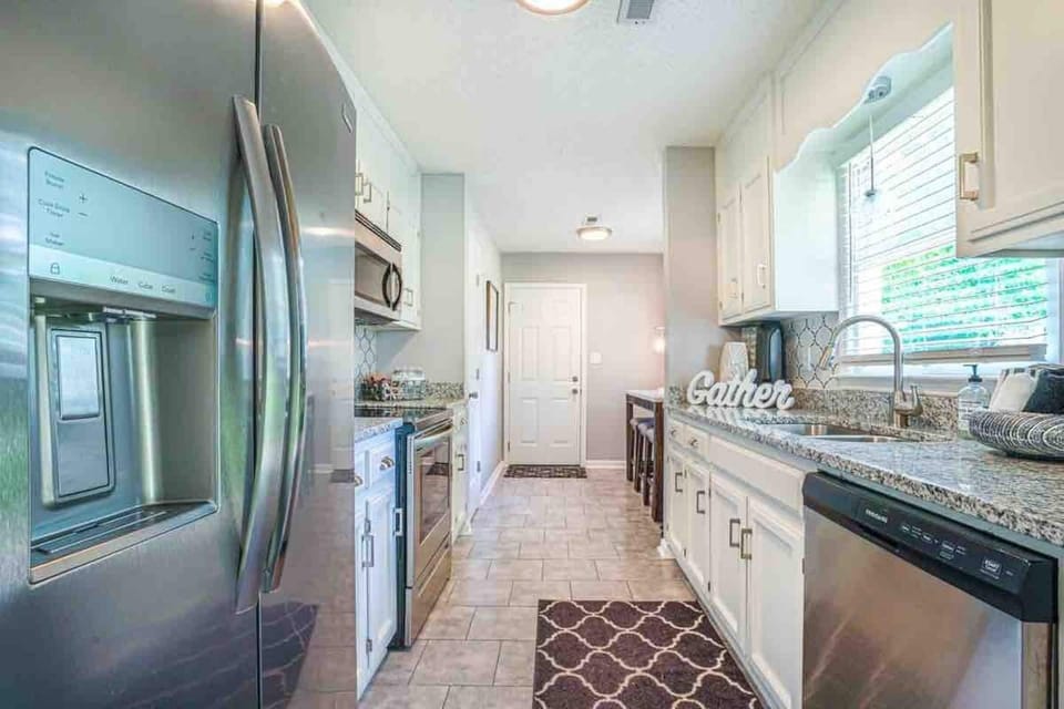 Kitchen with stainless steel appliances. Ice maker with crushed and cubed ice. 