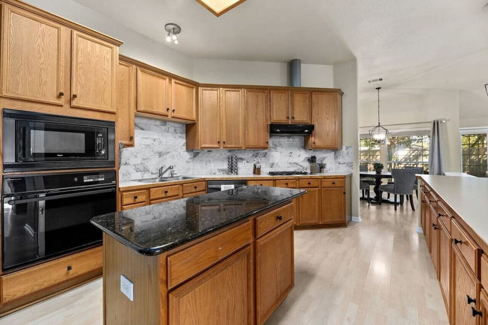 Spacious kitchen with granite island, modern appliances, and plenty of prep space—perfect for group meals or extended stays.