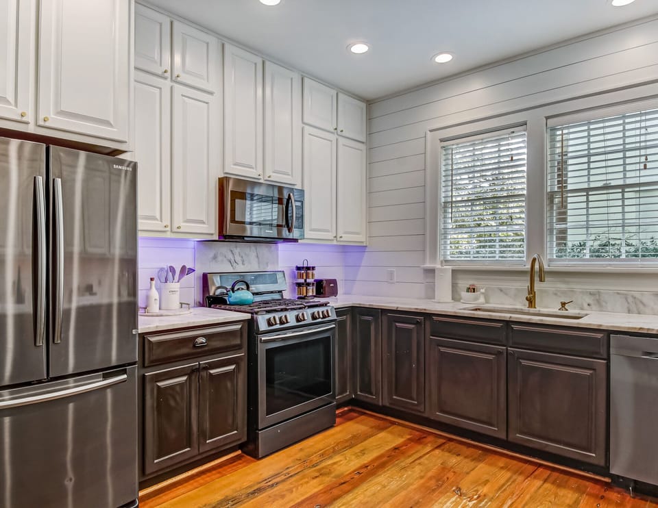The fully renovated kitchen features black stainless appliances and colorful LED "party" lights under the cabinets.