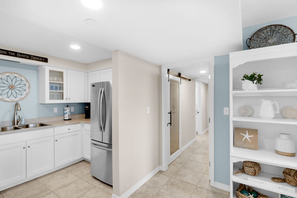 Spacious and open kitchen leading into hallway