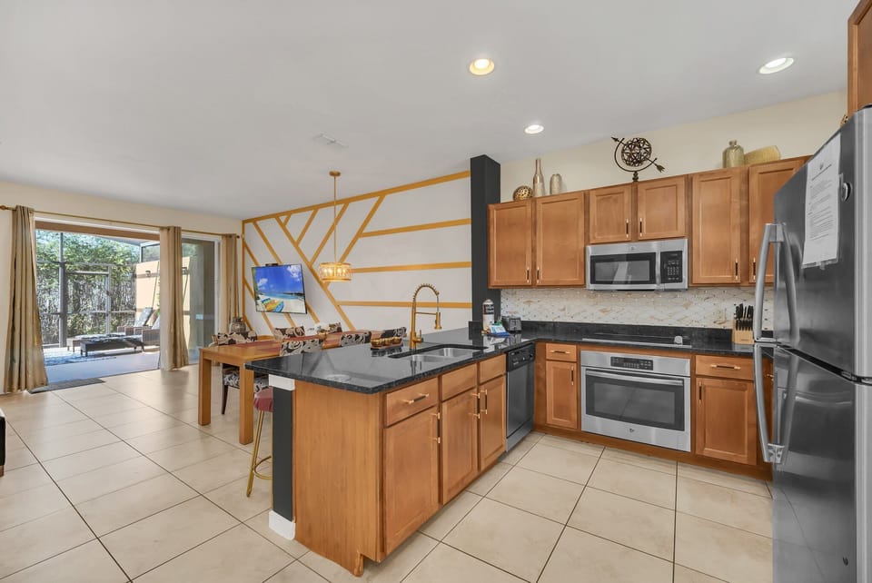 Large, open kitchen with stainless appliances and solid surface counters