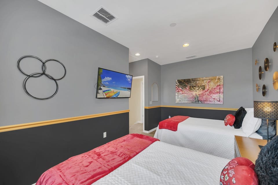 Spacious guest room with 2 double beds and televison