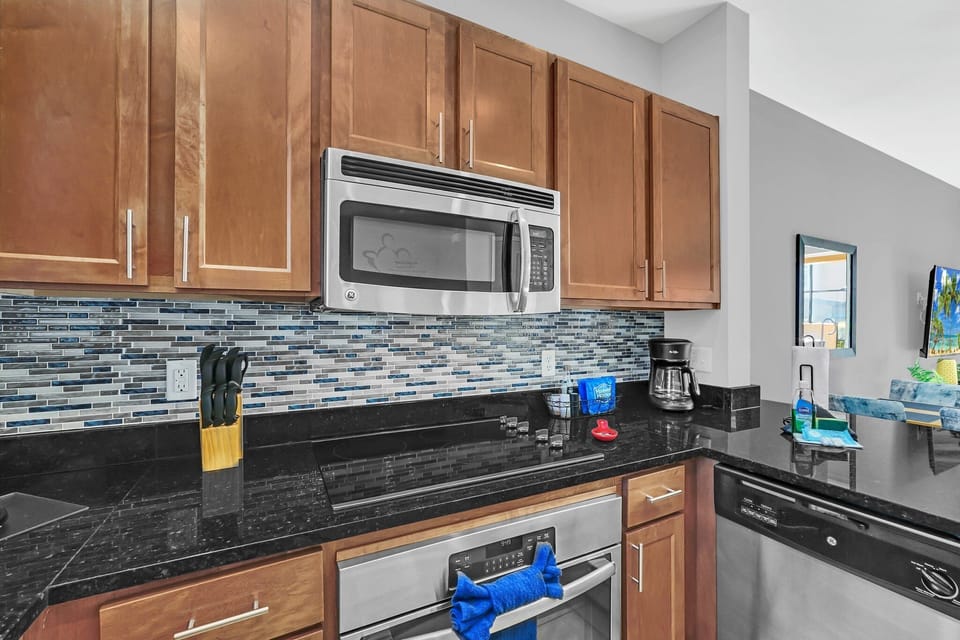 Spacious open kitchen with stainless appliances and solid surface countertops