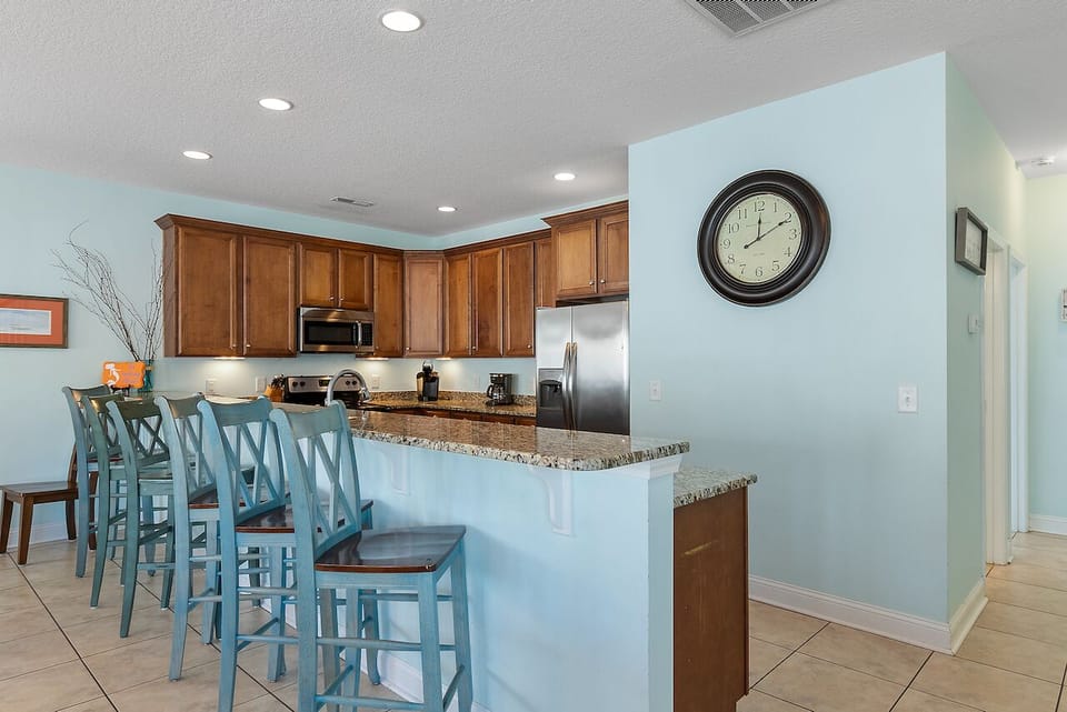 Your fully equipped kitchen features granite countertops and breakfast bar seating for casual meals.