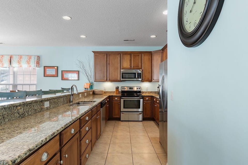 Your fully equipped kitchen features granite countertops, warm wood cabinets, and stainless steel appliances for creating memorable meals together.