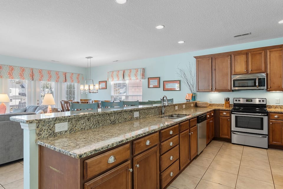 Your spacious kitchen features granite countertops and stainless appliances, flowing seamlessly into the dining area for memorable meals together.