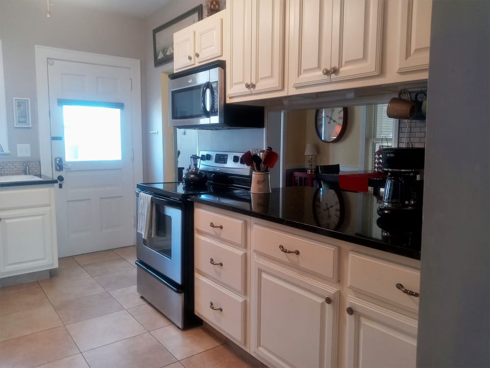 A very well equipped kitchen with granite countertops and stainless appliances.