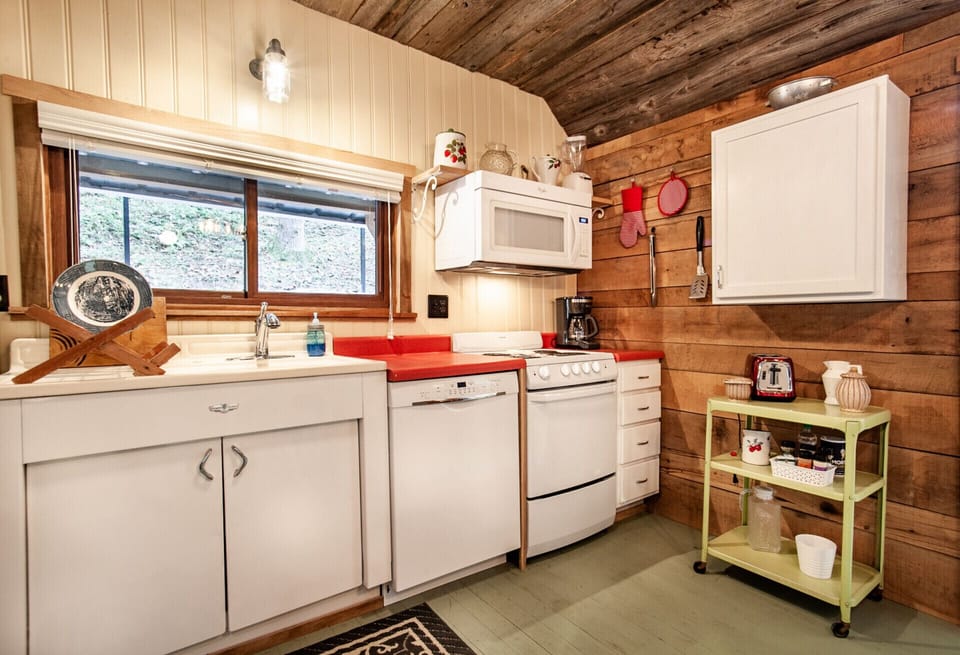 Step into this rustic kitchen retreat, where vintage charm meets modern convenience. From the wooden ceilings to the retro appliances, it’s a cozy space for any home chef.