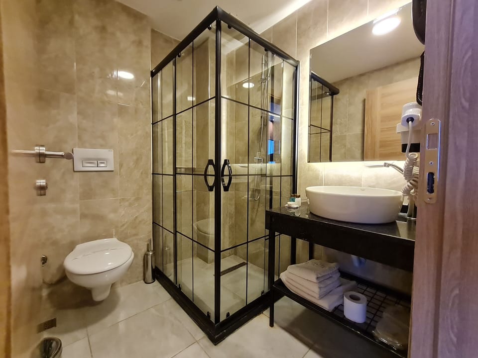 Shower, hair dryer, slippers, towels