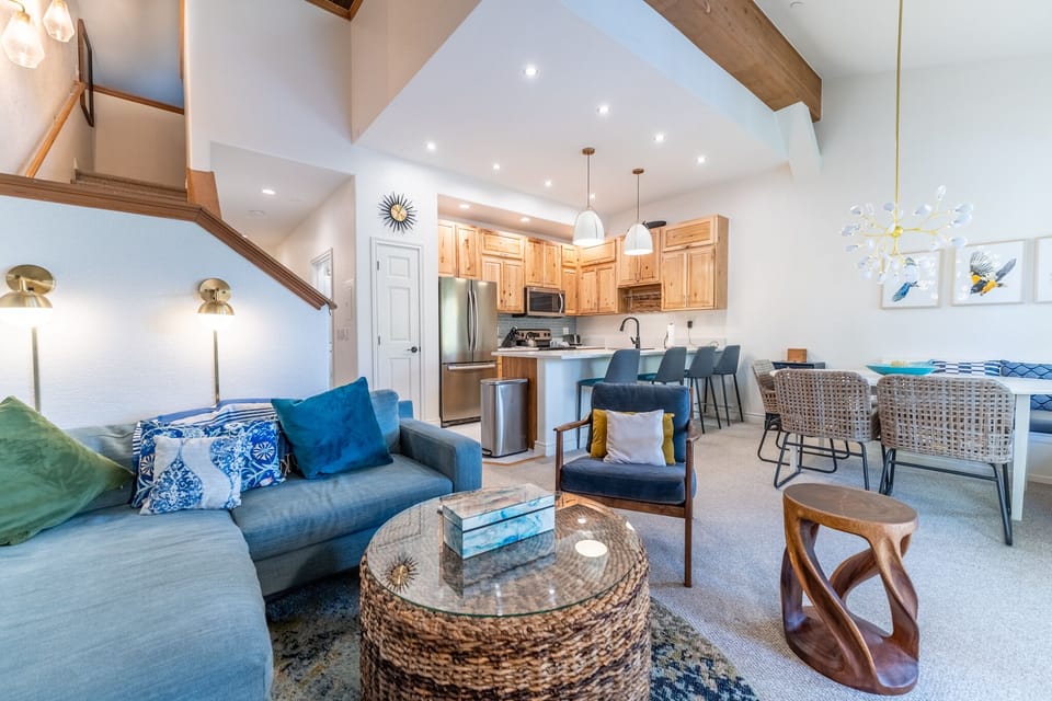 Unwind in your stunning open-concept retreat with soaring vaulted ceilings, coastal-inspired décor, and a fully-equipped kitchen perfect for memorable meals.
