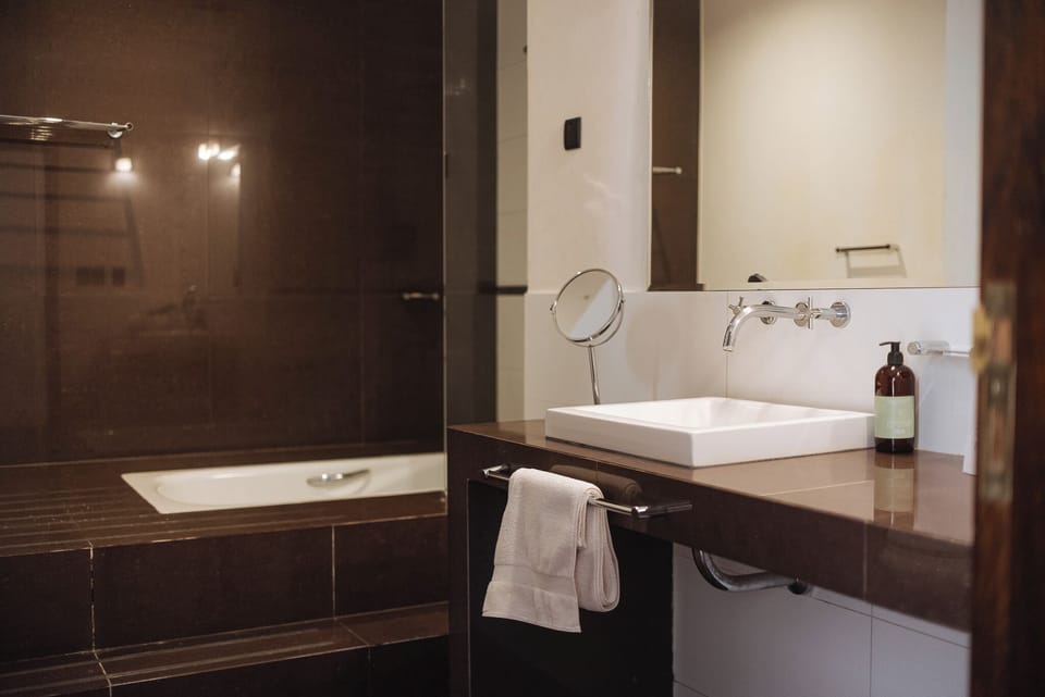 Deluxe Studio Suite | Bathroom | Designer toiletries, hair dryer, bidet, towels