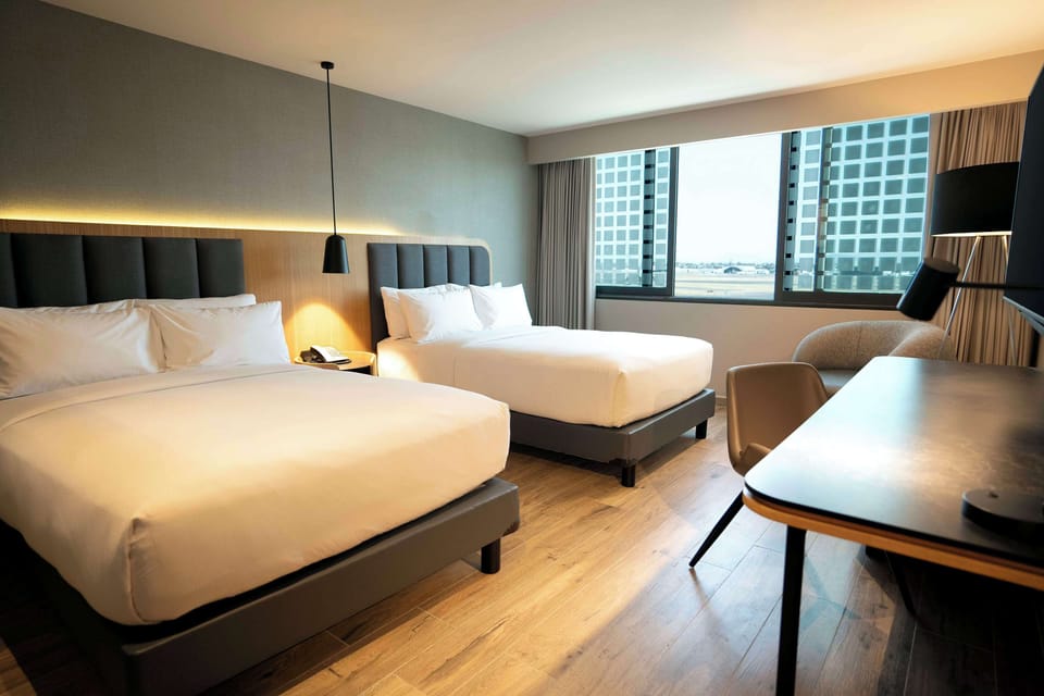 Room, 2 Double Beds (Airstrip view) | Premium bedding, Select Comfort beds, in-room safe, desk
