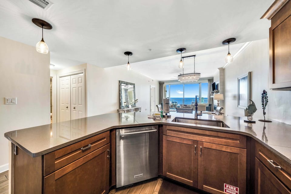 The fully equipped kitchen features quartz countertops, stainless-steel appliances, and has everything you need to prepare meals for family & friends.