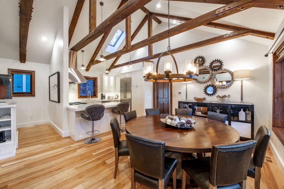 Dining table with bar area adjacent to open, updated kitchen