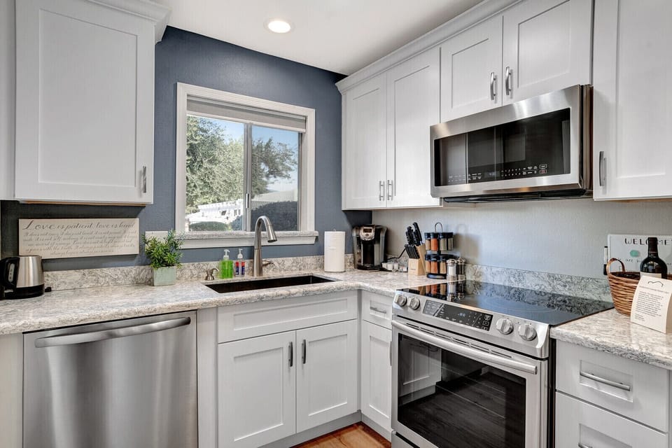 Kitchen with a Keurig Coffee Maker, cream, and coffee pods. 