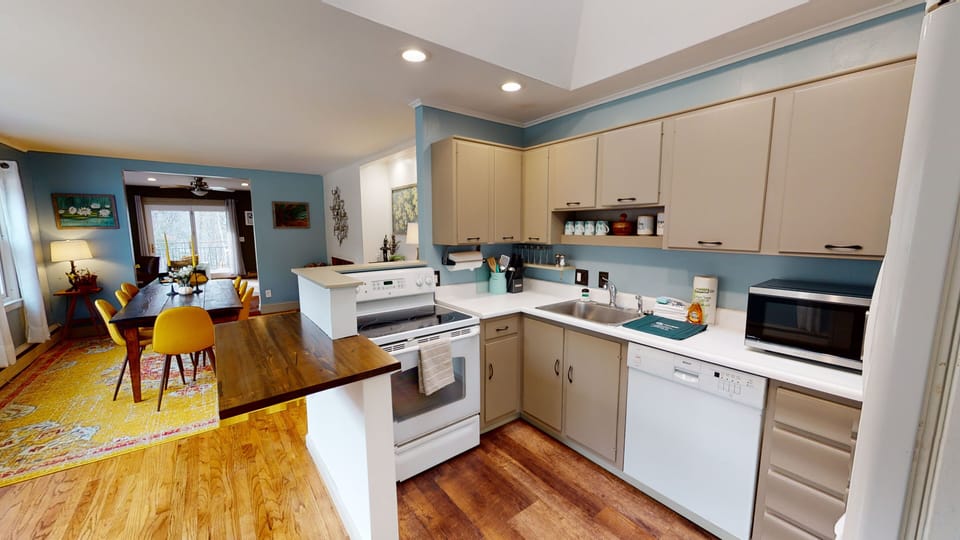 Fully equipped kitchen with an electric range, ample cabinet storage, and plenty of prep space.