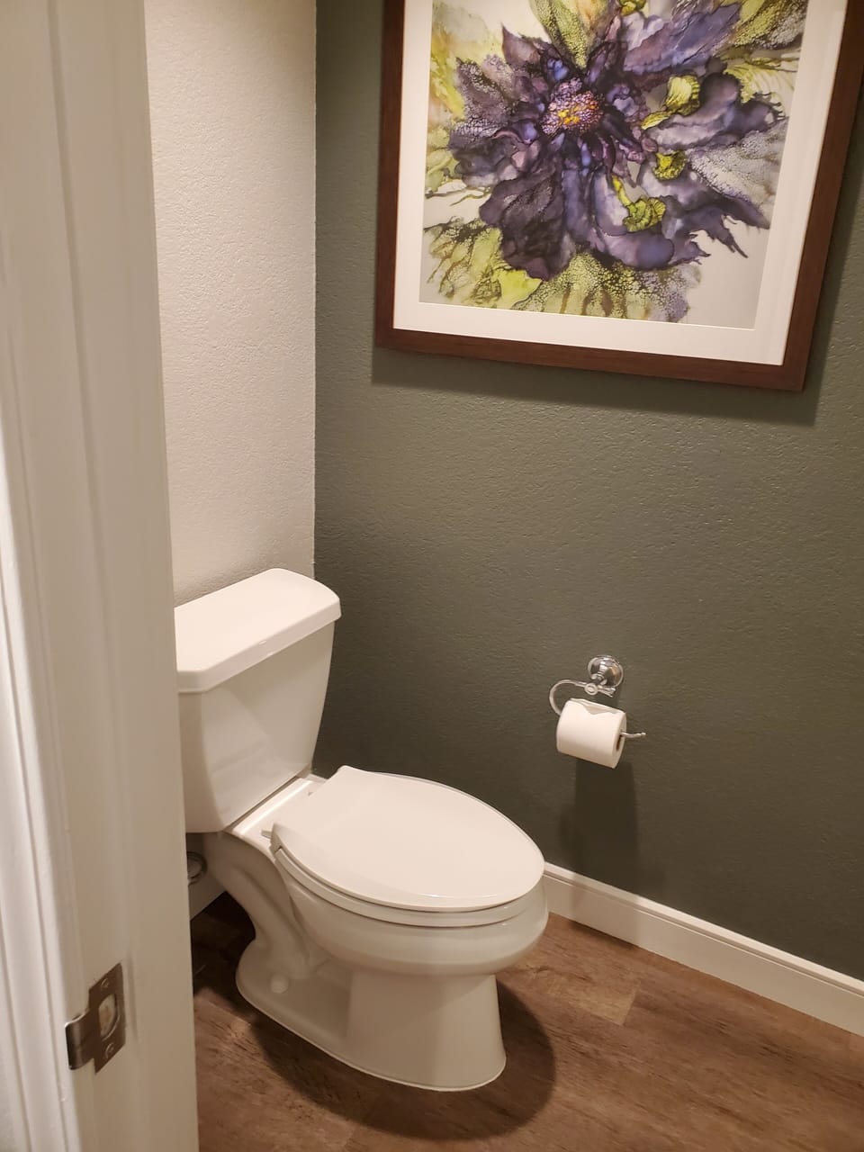 Bathroom has toilet and shower. Vanity area and soaking tub are in separate area