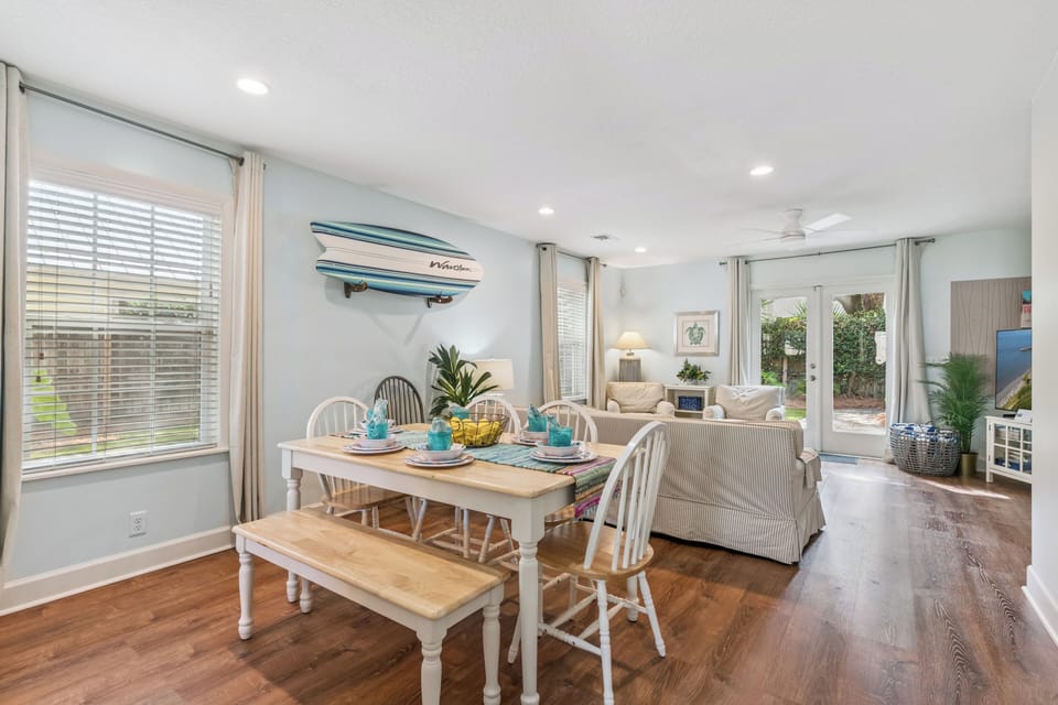 Sunlit open-plan space with a beachy vibe where you can share meals around the farmhouse-style table, then unwind on the cozy sofa. Your private patio awaits just beyond the glass doors.