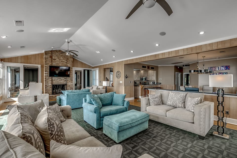 Open living room — comfy seating, fireplace, and ocean views