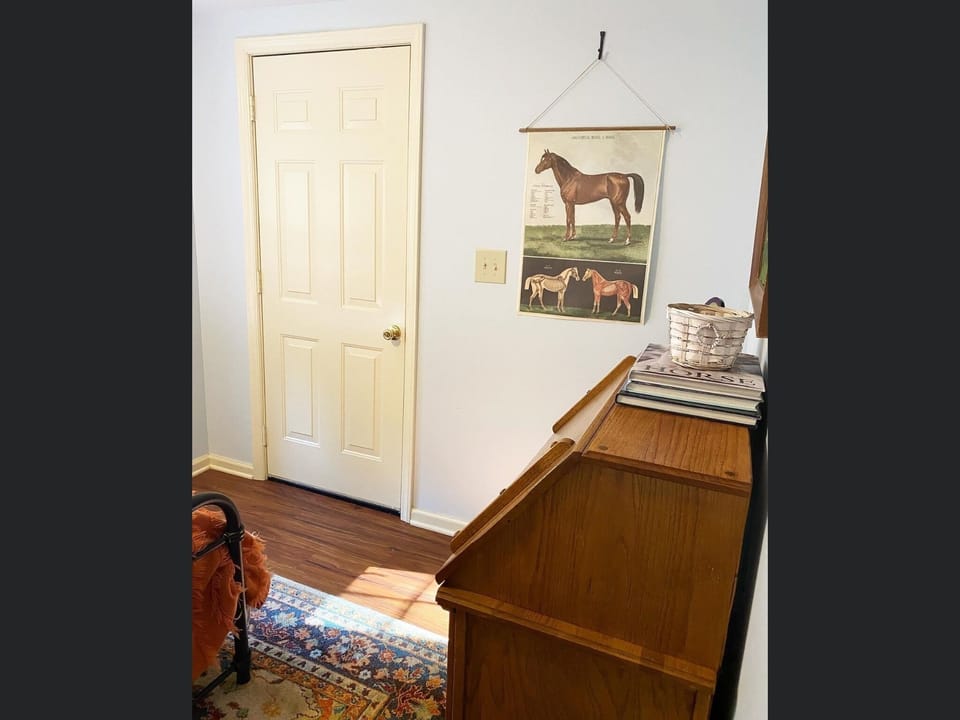 Downstairs bedroom has door to large porch.  Yes, this house has 3 porches! 