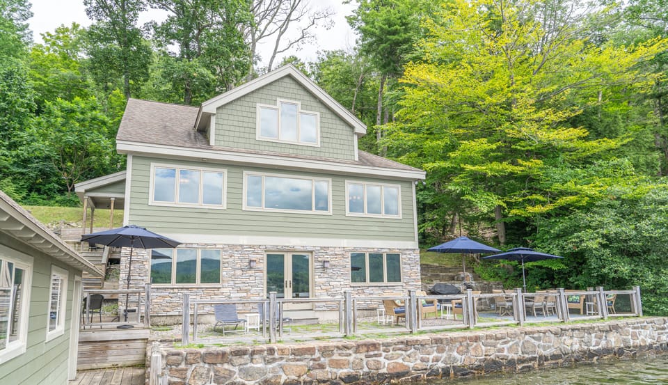 Lakeside view of the home and patio area. 