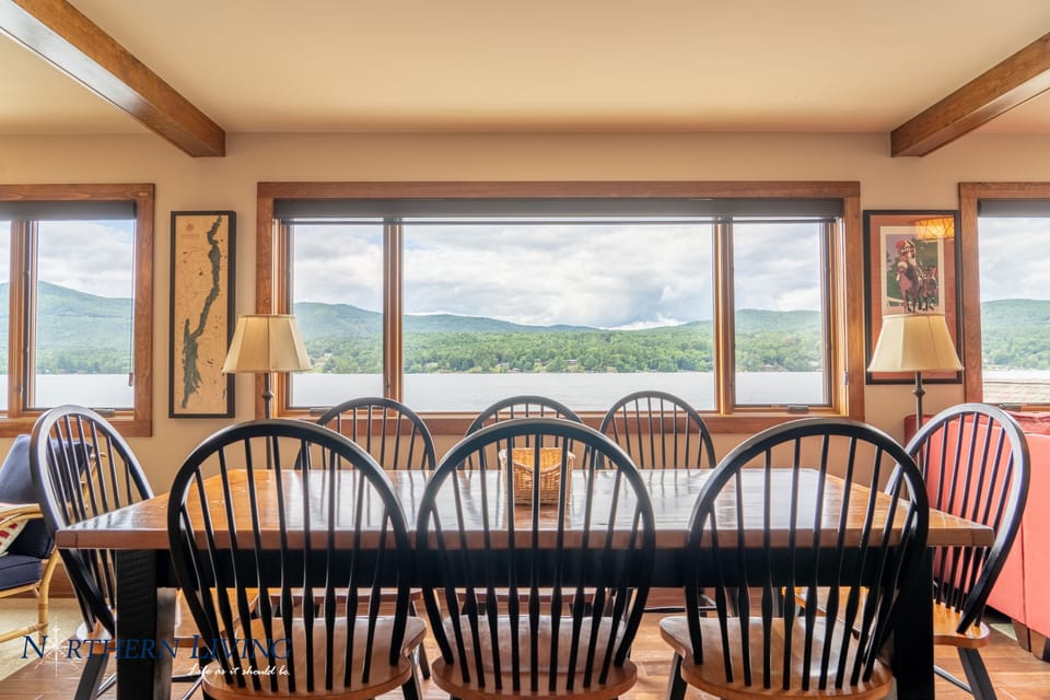 Dining area with a lake view through large windows. 