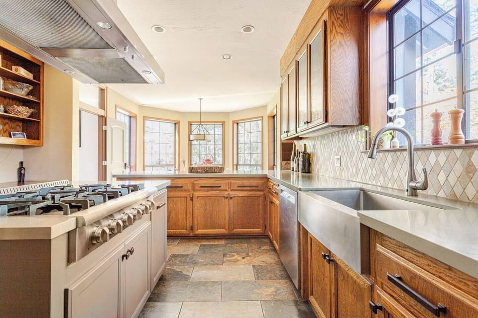 Kitchen with 10-seat dining table, fridge, double oven, toaster, coffee machine