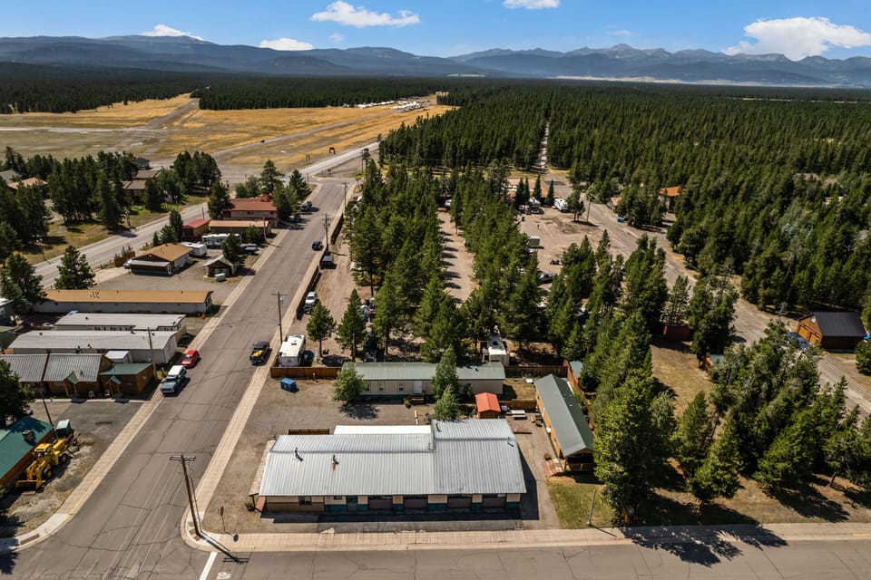 Aerial view of property with view of local area and surrounding Gallatin National Forest.