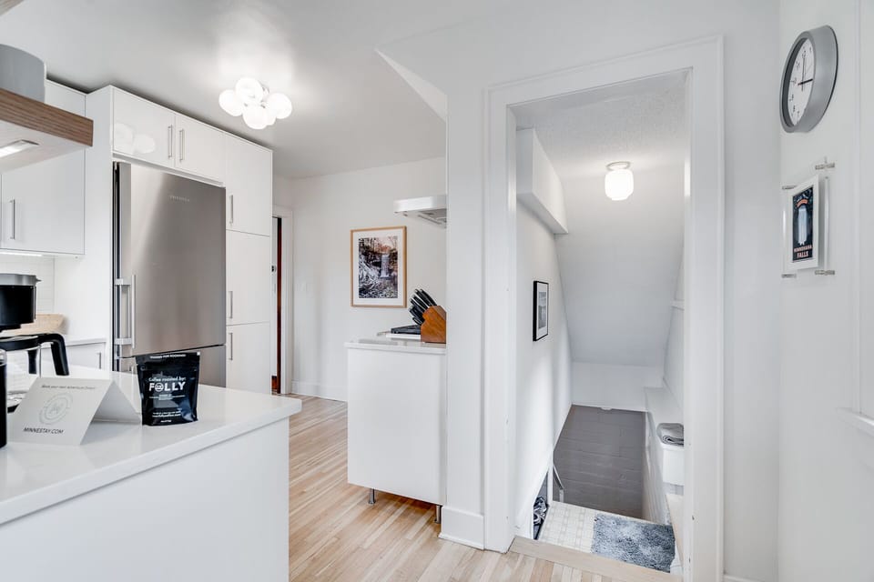 Your fully equipped kitchen features modern appliances and a sleek stainless steel refrigerator, perfect for preparing meals during your stay.