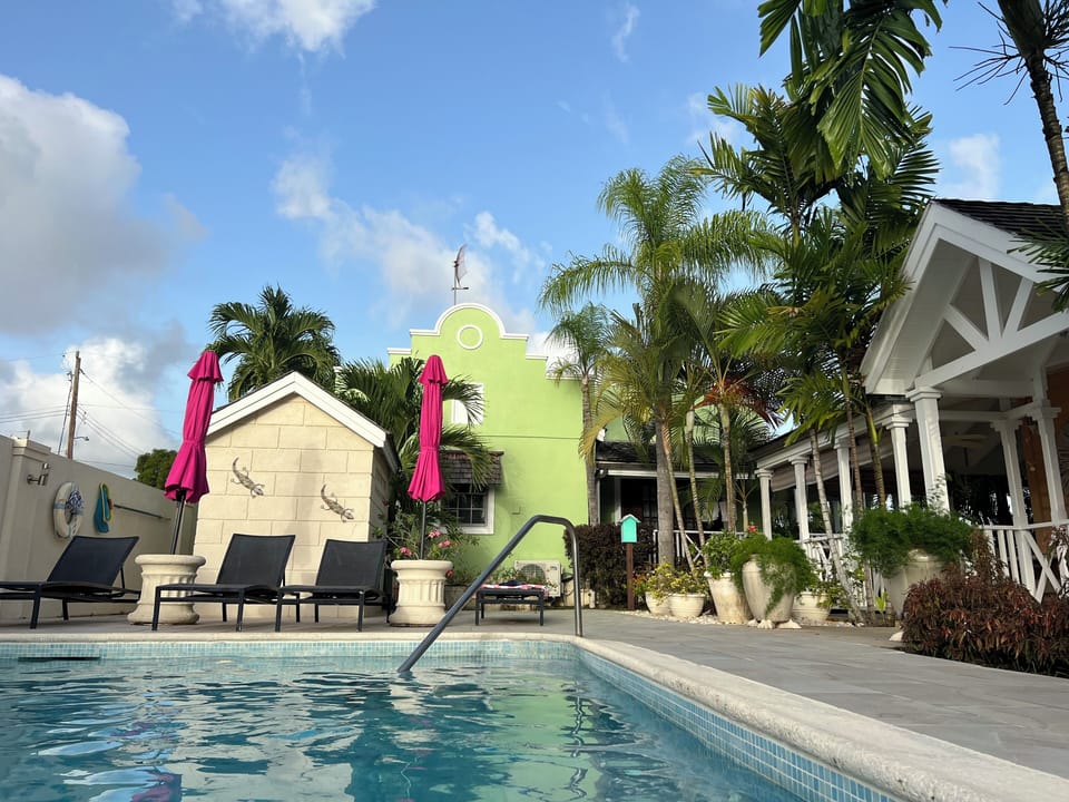 No. 7 viewed from the pool. Green villa with part of the verandah visible.
