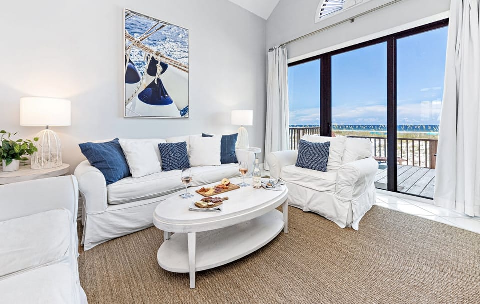 Spacious living room with comfortable sofas and extraordinary Gulf views